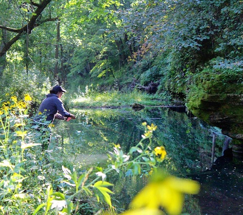 Laurel Monaghan fishing on a river