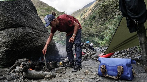 Building a fire to cook with a watershed drybag nearby