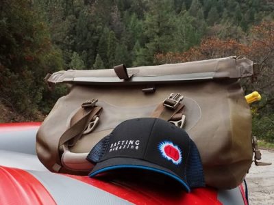 Image by raftingmagazine with a Watershed Drybag and a Rafting Magazine hat resting on a raft