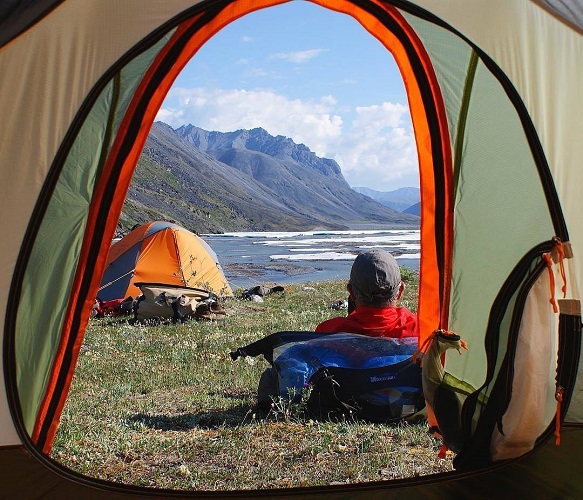 view from a tent with a mountain and lake view 