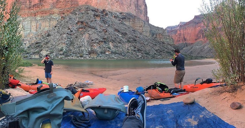 Campsite by the river and canyon with watershed drybags in view