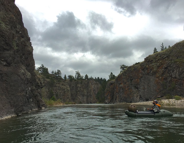 Paddling in a raft up to steep canyons