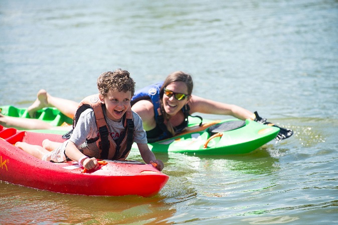 Kid and Mom smiling on a Bellyak