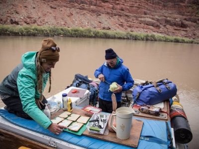 Two people preparing lunch on a raft