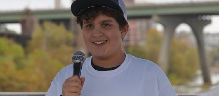 Nathaniel Milligan smiling and talking into a microphone