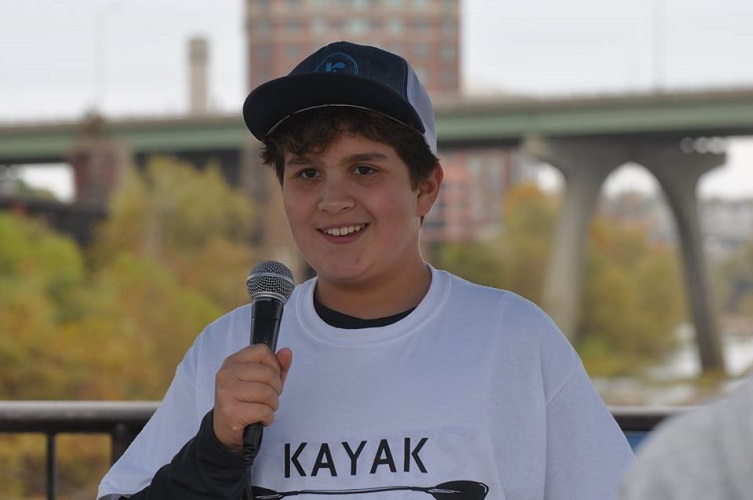 Nathaniel Milligan smiling and talking into a microphone 