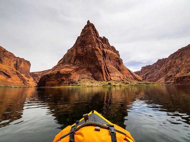 Watershed Drybag on the edge of a boat floating through a canyon