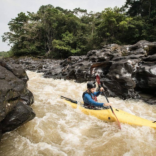 Kayaker paddling down a river